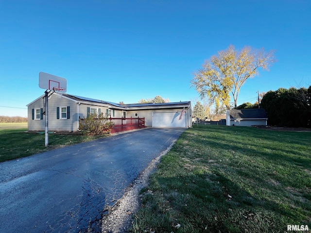 view of front of property featuring solar panels, a wooden deck, and a front lawn