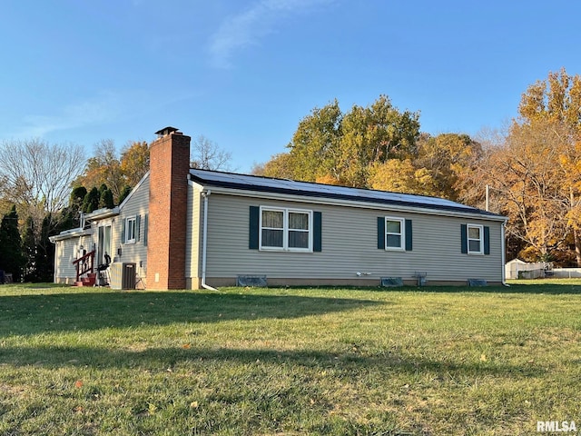 view of home's exterior featuring a lawn and central air condition unit