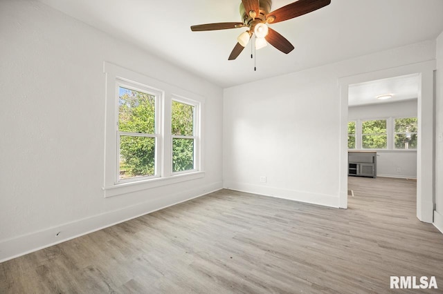 empty room with light hardwood / wood-style floors and ceiling fan