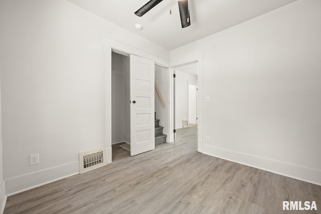 unfurnished bedroom with a closet, ceiling fan, and light hardwood / wood-style flooring