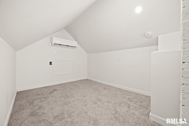 bonus room with vaulted ceiling, a wall mounted air conditioner, and light colored carpet