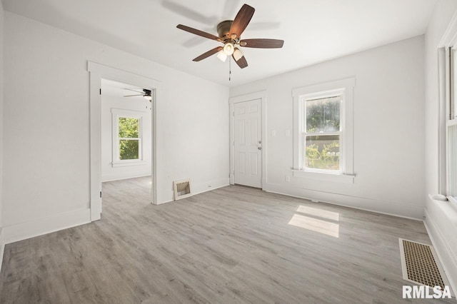 unfurnished room with light wood-type flooring and ceiling fan