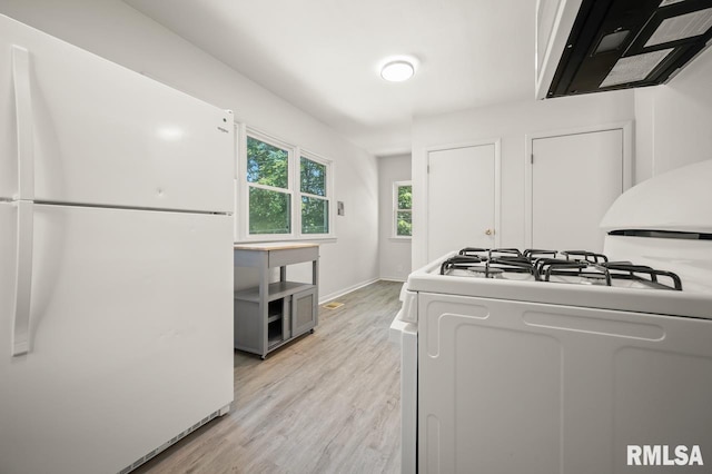 kitchen featuring white appliances, light wood-type flooring, and ventilation hood