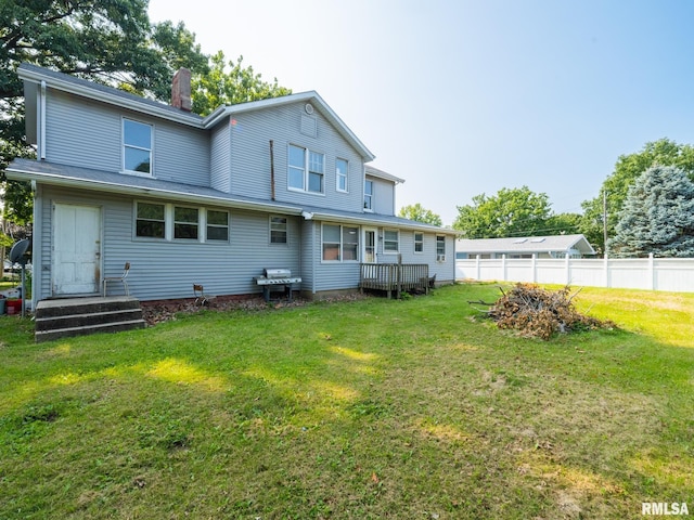 rear view of property with a yard