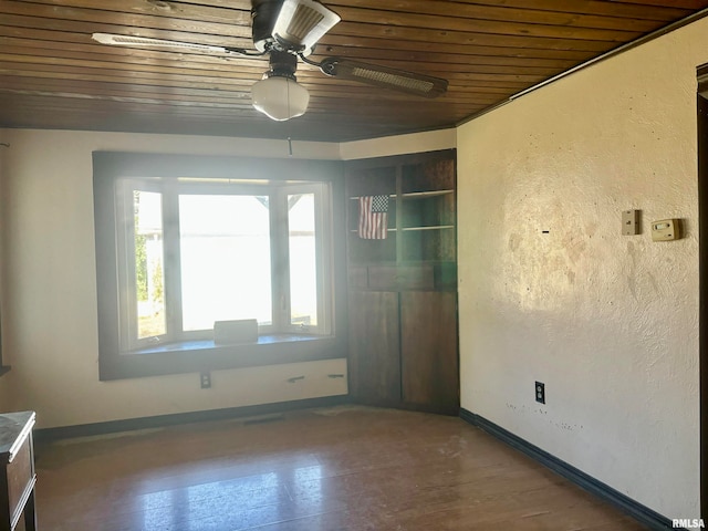 unfurnished room featuring wood-type flooring, wooden ceiling, and ceiling fan