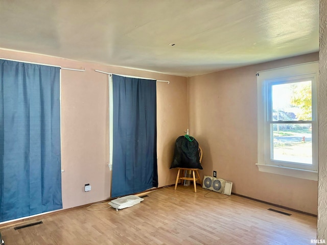 empty room with hardwood / wood-style floors