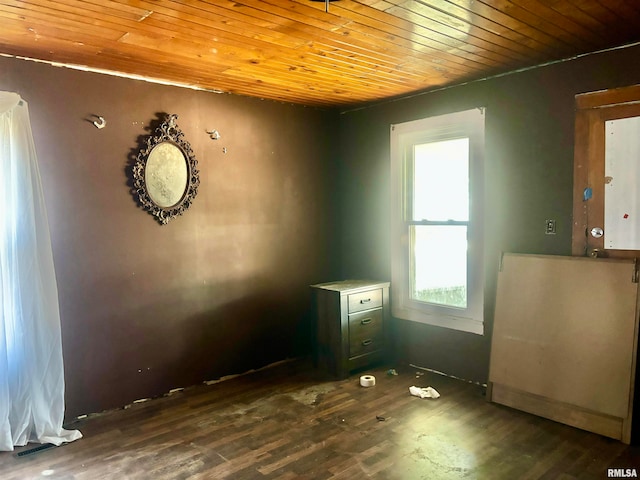 empty room featuring wood ceiling and dark hardwood / wood-style floors