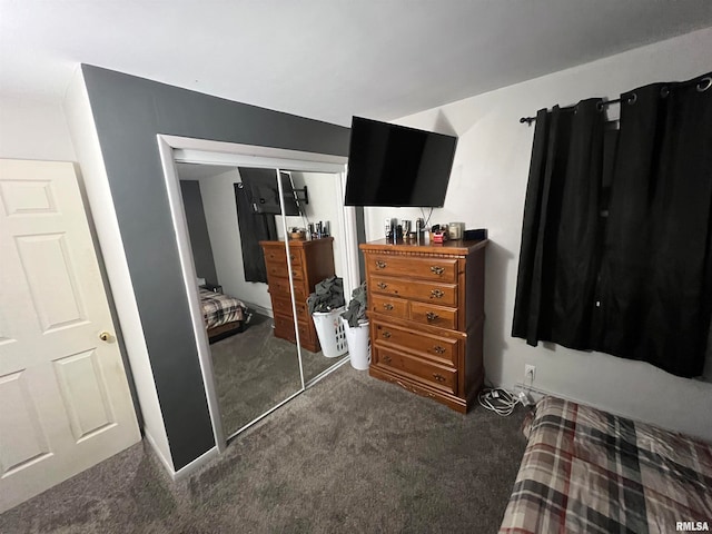 bedroom with a closet and dark carpet