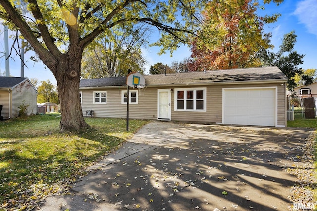 ranch-style home with cooling unit, a garage, and a front lawn