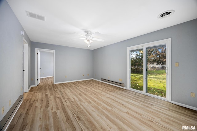 spare room featuring ceiling fan, light hardwood / wood-style flooring, and baseboard heating