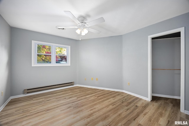 unfurnished bedroom featuring light hardwood / wood-style floors, baseboard heating, and ceiling fan