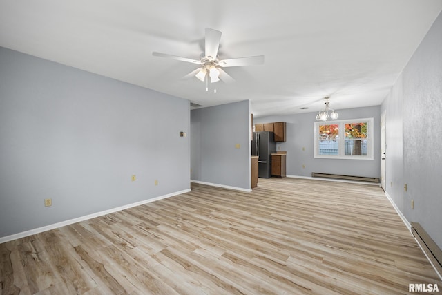 unfurnished living room featuring baseboard heating, ceiling fan with notable chandelier, and light wood-type flooring