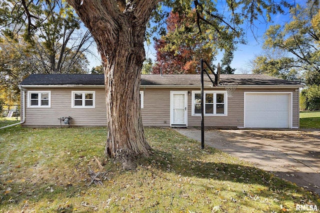 ranch-style house featuring a front yard and a garage