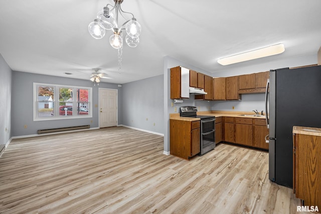 kitchen with a baseboard heating unit, decorative light fixtures, light wood-type flooring, appliances with stainless steel finishes, and ceiling fan with notable chandelier