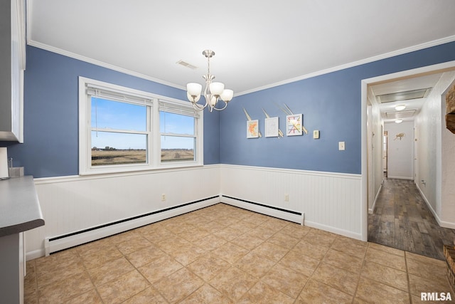 unfurnished dining area featuring wood-type flooring, crown molding, and a notable chandelier