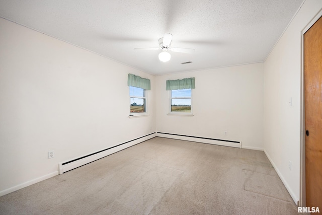 carpeted empty room featuring baseboard heating, ornamental molding, a textured ceiling, and ceiling fan