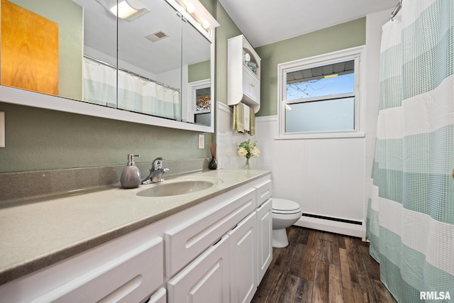 bathroom featuring vanity, hardwood / wood-style floors, curtained shower, a baseboard radiator, and toilet