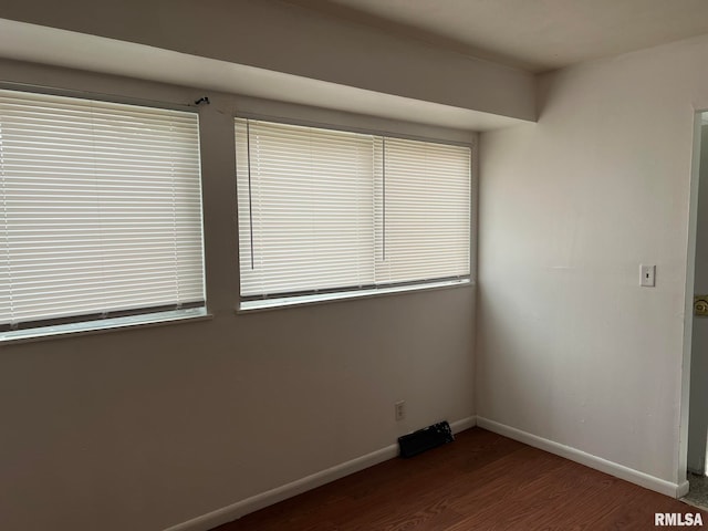 empty room featuring dark wood-type flooring