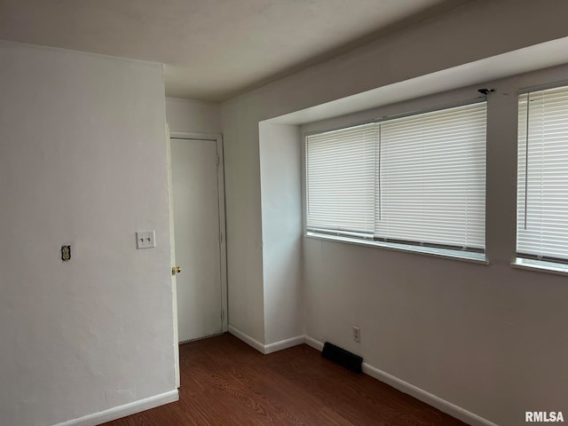 unfurnished bedroom with dark hardwood / wood-style floors