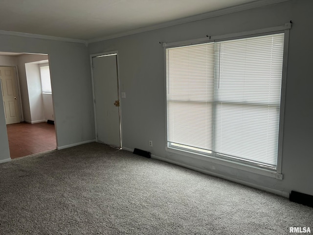 carpeted spare room featuring ornamental molding