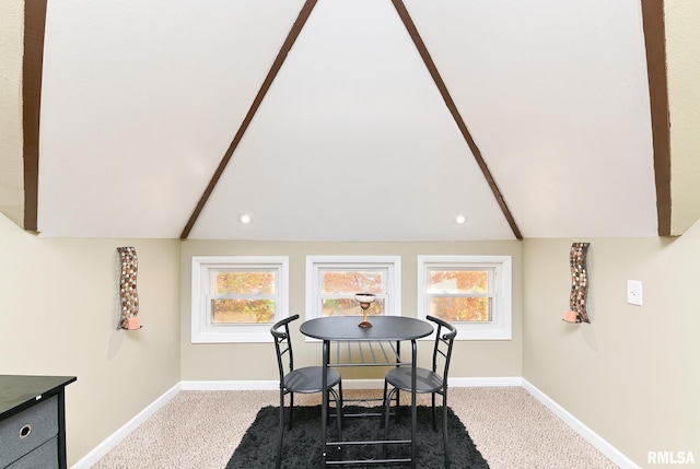 dining area featuring vaulted ceiling with beams, plenty of natural light, and carpet floors