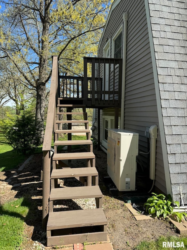 wooden deck featuring ac unit