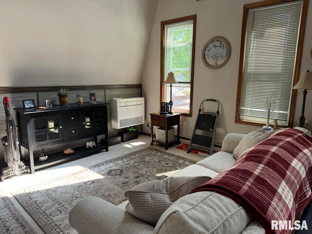 carpeted living area featuring heating unit