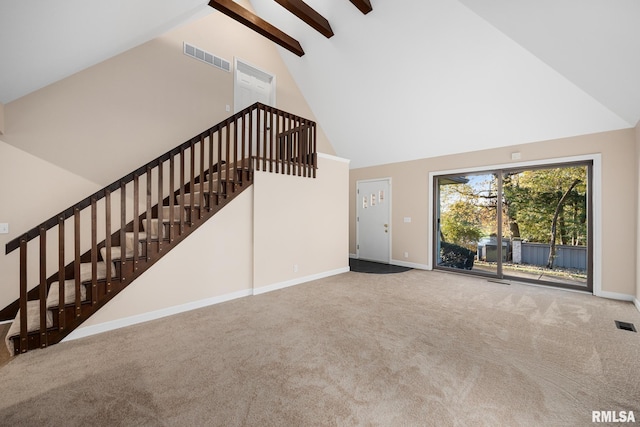 unfurnished living room featuring carpet and high vaulted ceiling