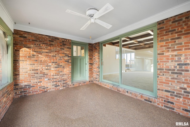 unfurnished sunroom with ceiling fan