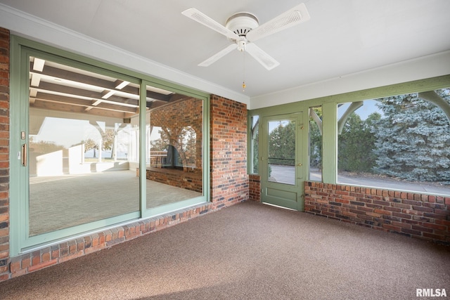 unfurnished sunroom with ceiling fan