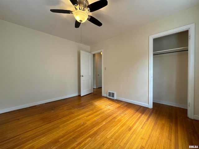 unfurnished bedroom featuring a closet, light wood-type flooring, and ceiling fan