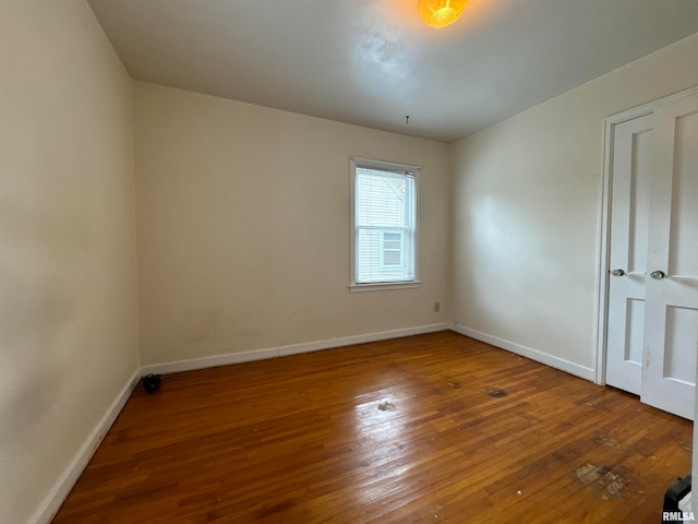 unfurnished room with wood-type flooring