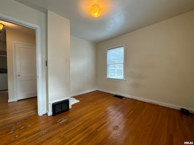 spare room with hardwood / wood-style flooring