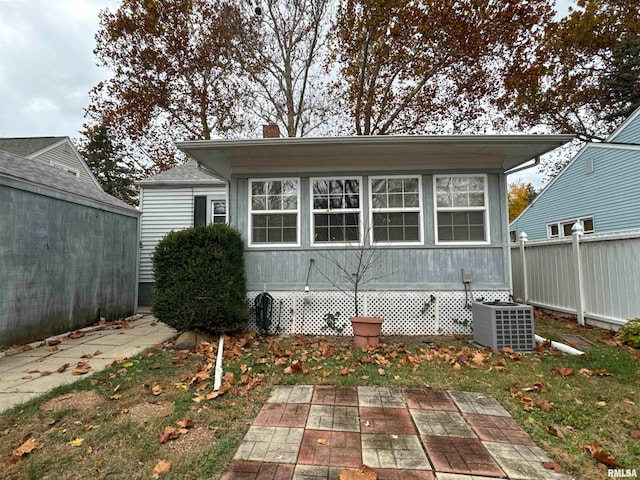 back of property with cooling unit and a patio