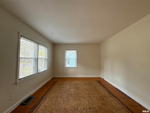 unfurnished room with hardwood / wood-style floors