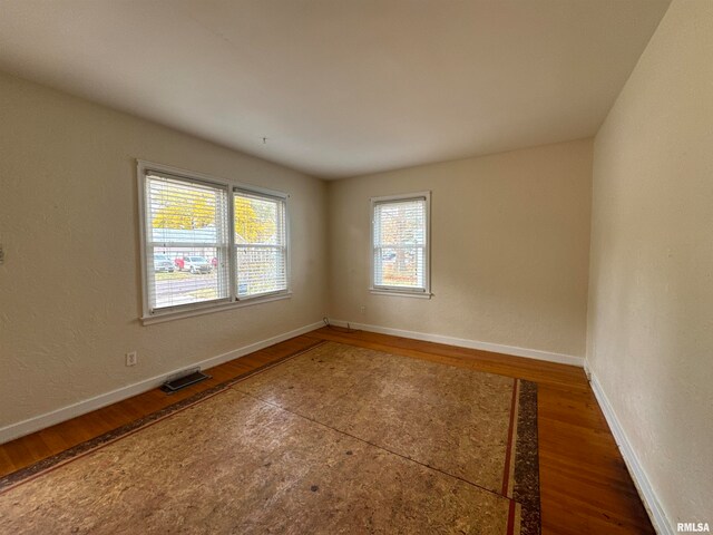 empty room featuring dark hardwood / wood-style flooring