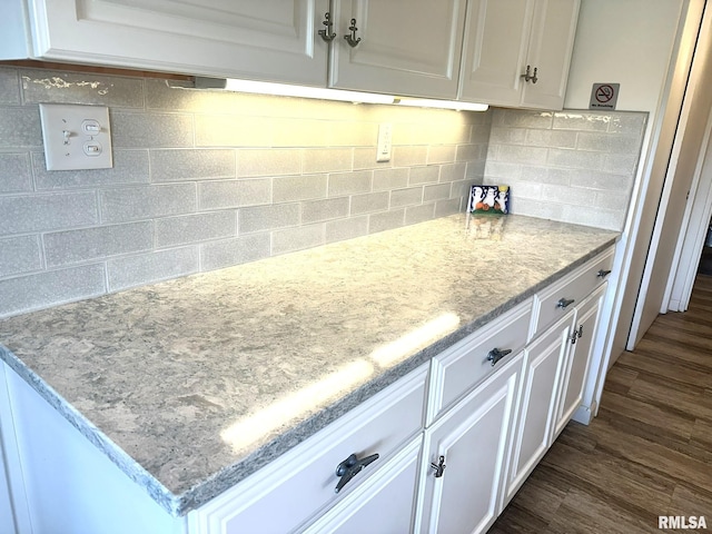 kitchen featuring dark wood-type flooring and white cabinetry