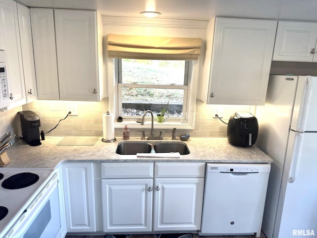 kitchen featuring white cabinets, backsplash, sink, light stone counters, and white appliances