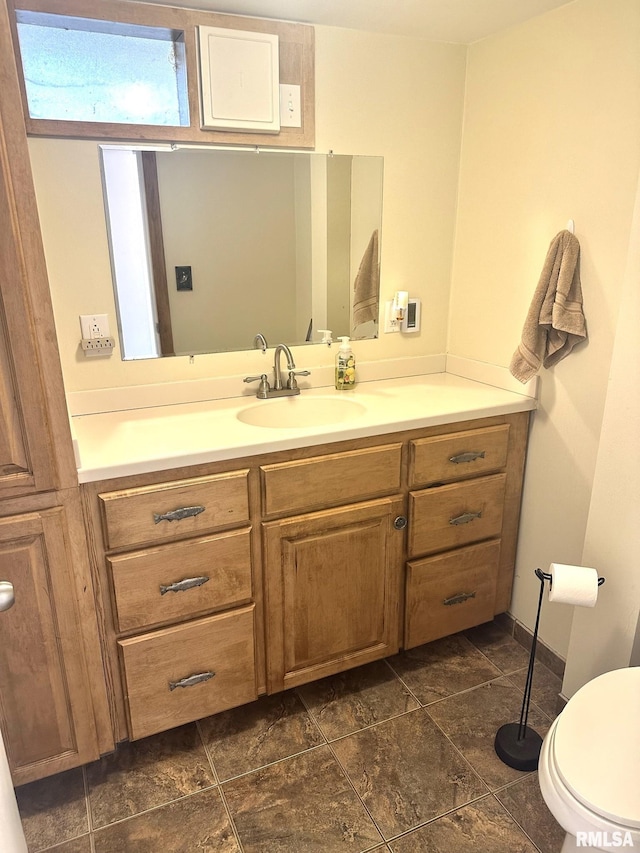 bathroom featuring vanity and toilet