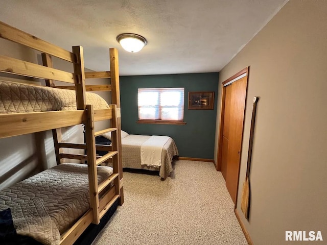 bedroom with a closet and light colored carpet