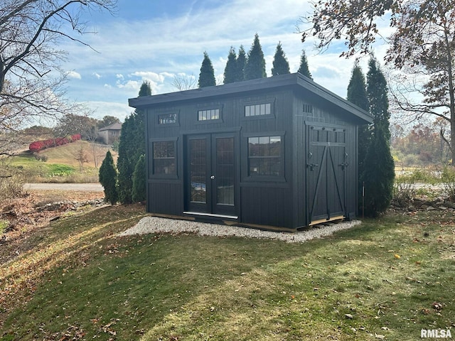 view of outbuilding with a yard