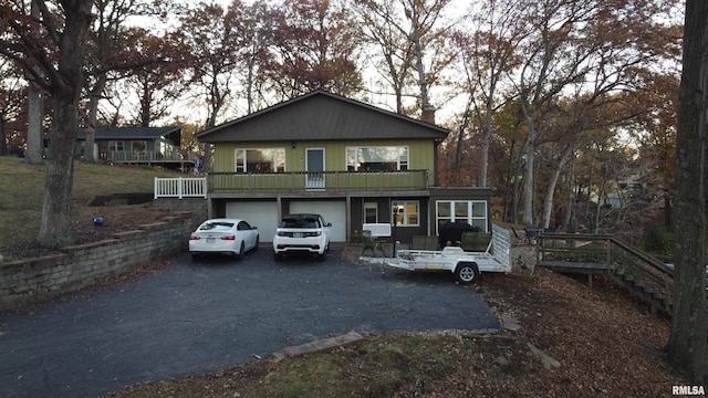 view of front property featuring a balcony and a garage