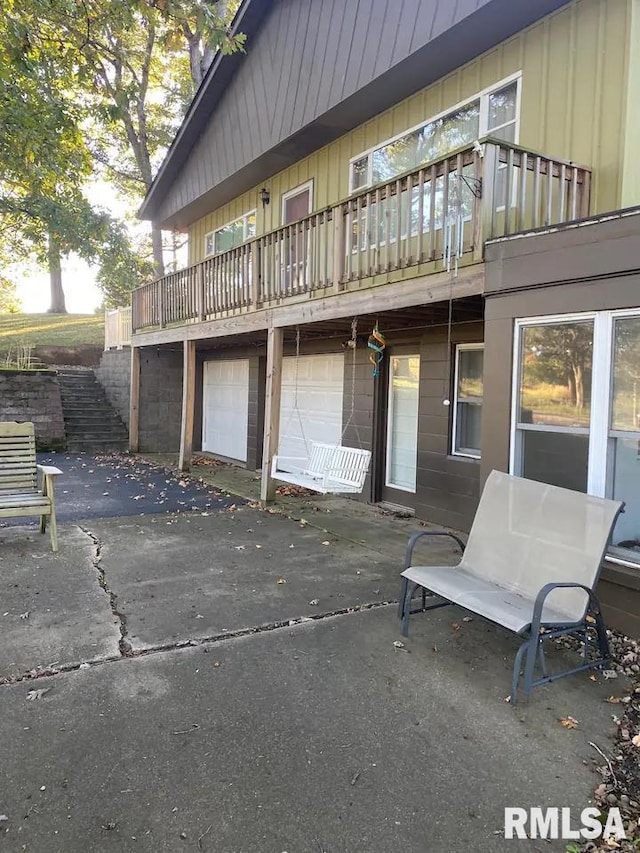 rear view of property featuring a garage