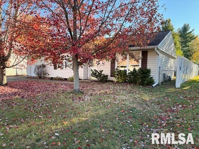 view of side of property featuring a yard