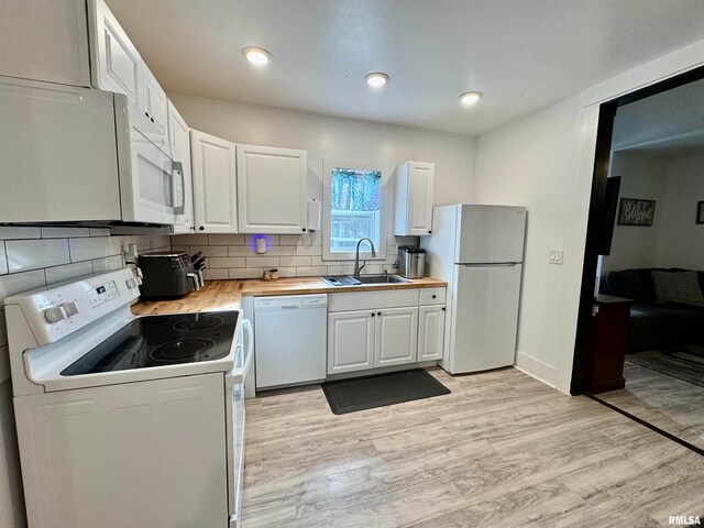 kitchen featuring light hardwood / wood-style flooring, sink, white cabinetry, butcher block countertops, and white appliances