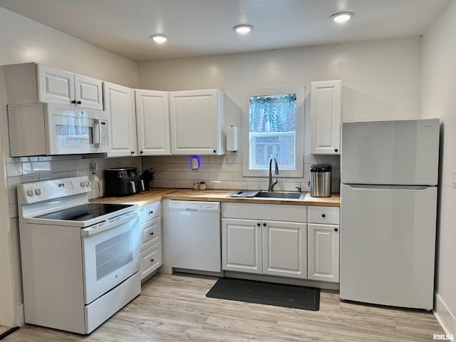631 S Mcarthur St, Macomb, IL 61455 - kitchen with white appliances, a sink, butcher block countertops, white cabinets, and backsplash