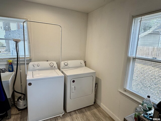 631 S Mcarthur St, Macomb, IL 61455 - laundry area featuring light wood finished floors, washer and dryer, plenty of natural light, and baseboards