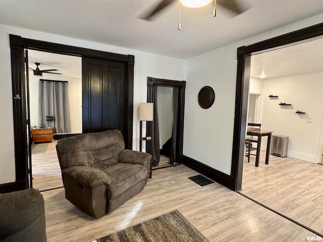 living room featuring light hardwood / wood-style floors and a textured ceiling