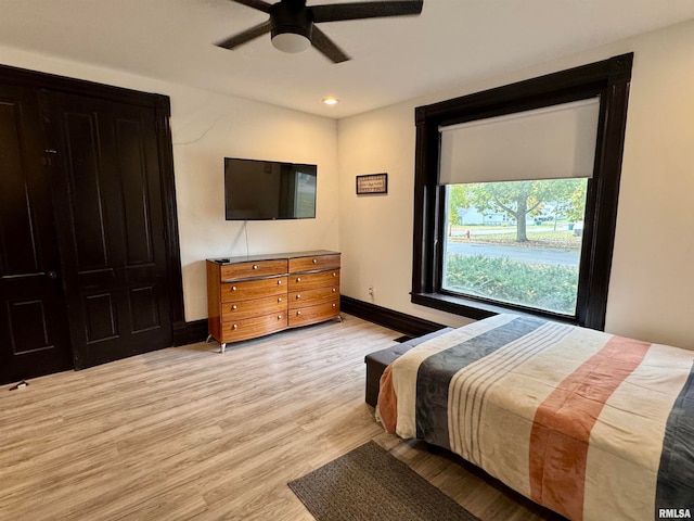 bedroom with light hardwood / wood-style flooring and ceiling fan