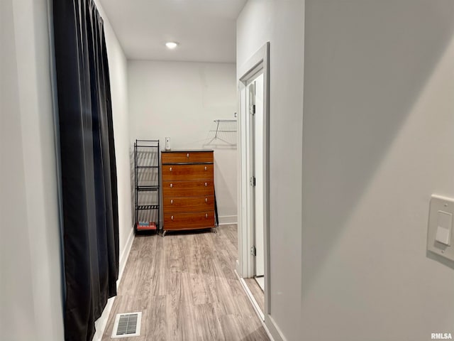 corridor with light hardwood / wood-style flooring